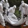 Health workers bury the body of a woman who is suspected of having died of the Ebola virus in Bomi county, Monrovia, Liberia